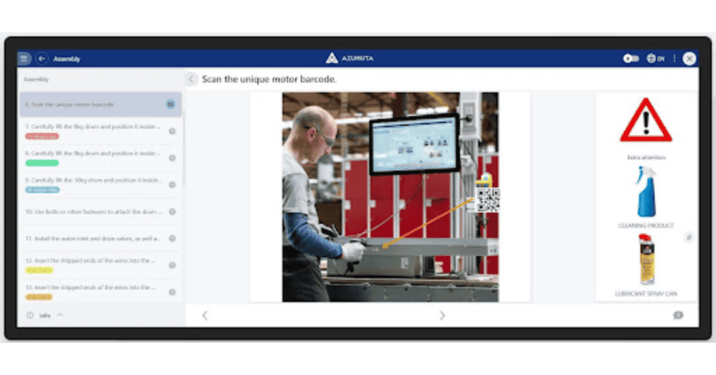 A person operates machinery while following assembly instructions displayed on a screen. The screen shows step-by-step guidelines, a caution sign, and images of cleaning and lubricating products for the process. A barcode scanning prompt is also visible.