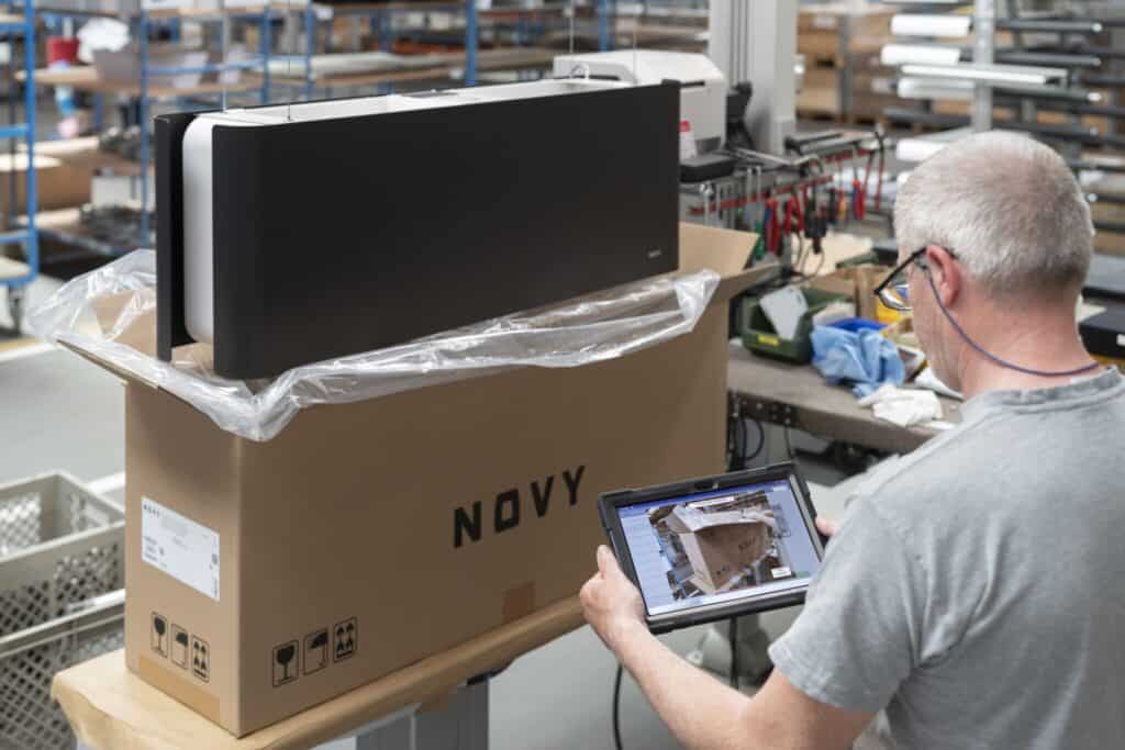 A person is inspecting a boxed item labeled 