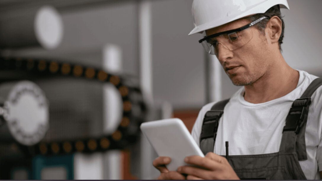 Ultimate guide to work instructions by Azumuta. Depicting an operator reviewing work instructions on a tablet