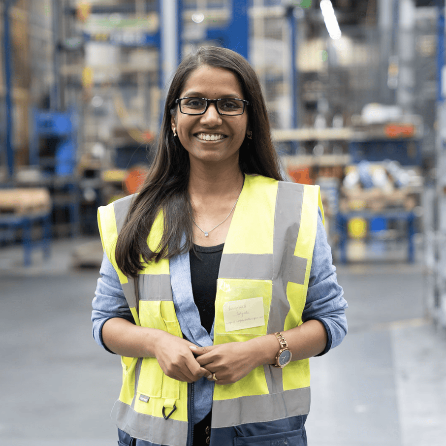 Profile picture of Swapnali, senior engineer at Atlas Copco, posing for the camera with a smile, hands slightly crossed, wearing a high vision vest.