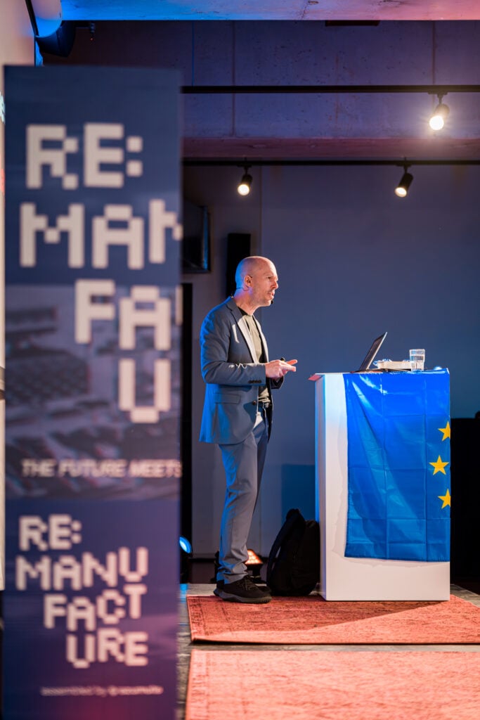 Tom Van de Weghe on stage at Re:Manufacture 2026